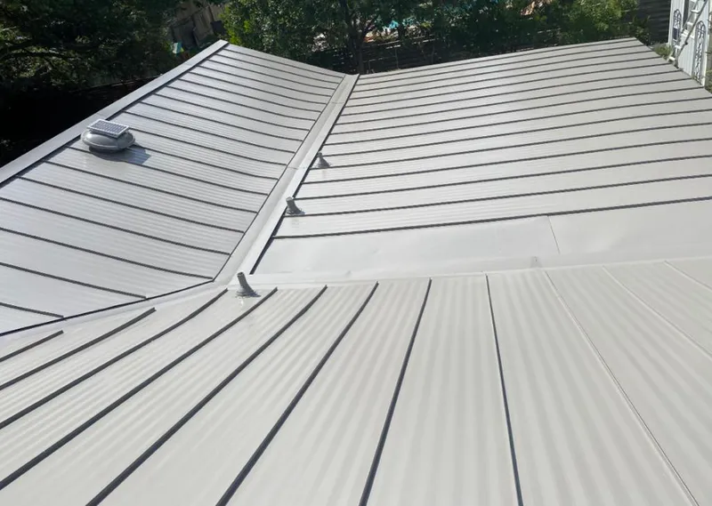 Solar attic fan installed on a metal roof for Roof Ventilation in Columbia
